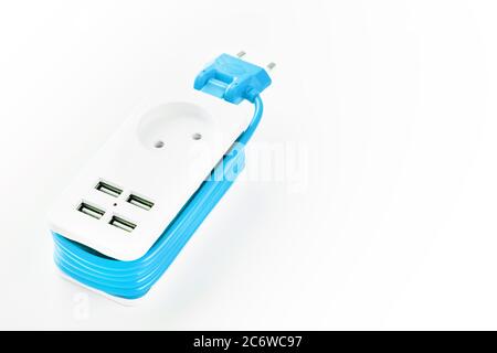 Extension Socket with USB Port on white background for charging phones and electronic devices, blue power cord. Stock Photo
