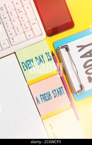 Writing note showing Every Day Is A Fresh Start. Business concept for an opportunity to start over without prejudice Empty papers with copy space on y Stock Photo