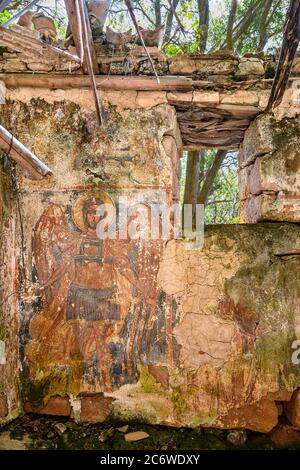 A worn fresco of  archangel Michael on the wall of a ruined chapel in the outer Mani, near Kardamyli, Peloponnese, Greece. Stock Photo