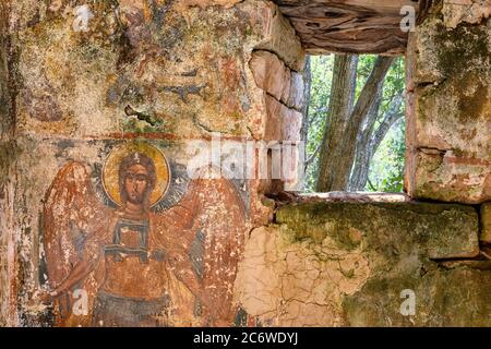 A worn fresco of  archangel Michael on the wall of a ruined chapel in the outer Mani, near Kardamyli, Peloponnese, Greece. Stock Photo