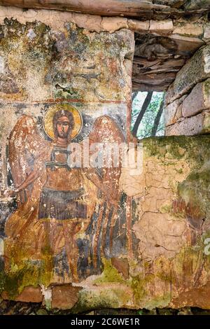 A worn fresco of  archangel Michael on the wall of a ruined chapel in the outer Mani, near Kardamyli, Peloponnese, Greece. Stock Photo