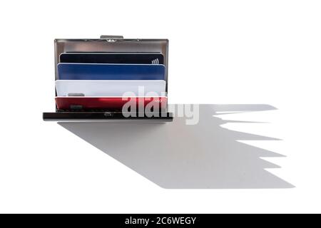 Stainless steel business ID credit card holder with credit cards, daylight and sharp shadow Stock Photo