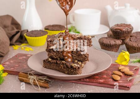 Chocolate biscuits with chocolate on a beige background. Biscuit day Stock Photo