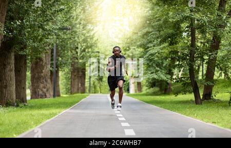 Athletic african man getting ready for marathon at park Stock Photo