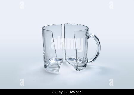Broken glass cup in half on white background Stock Photo