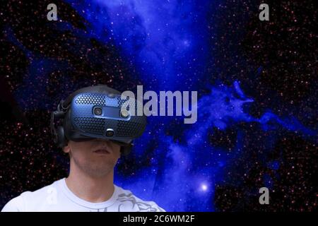 Shocked man in virtual reality against the background of space Stock Photo