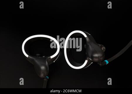 Virtual reality controllers with a led light on black background Stock Photo