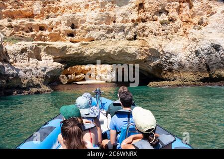 A group of tourist in a boat visiting the caves of Benagil Stock Photo