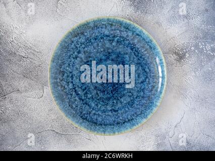 Top view of round plate for pizza on contrast textured blue background Stock Photo