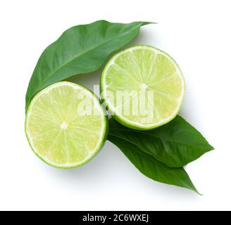 Sliced limes with green leaves isolated on white background. View from above Stock Photo
