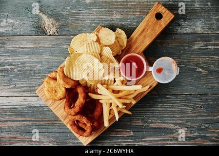 Unhealthy and junk food. Different types of fastfood and snacks on the table, close up. Takeaway food Stock Photo
