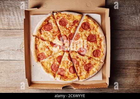 Slice of pizza in cardboard box, close up Stock Photo