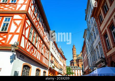 Mainz, Germany, August 24, 2019: Traditional german houses with typical wooden wall fachwerk style and Mainz Cathedral or St. Martin's Cathedral building in historical medieval town centre Stock Photo