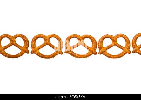 Pretzels in a row isolated on white background Stock Photo