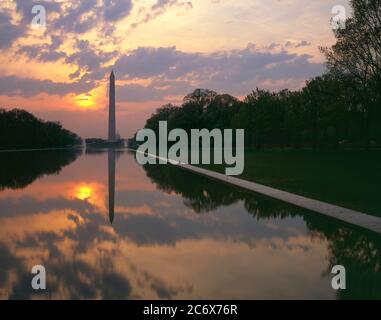 Washington D.C./APR Sunrise beyond Washington Monument over reflecting pool with Capital beyond. The Washington monument was finished in 1884 and is t Stock Photo
