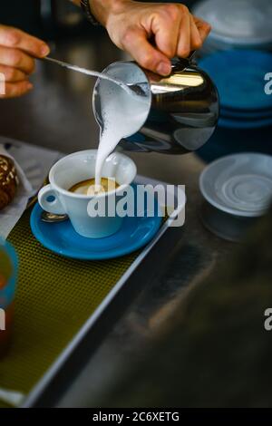 Hands of young adult caucasian female barista at work preparing Stock Photo