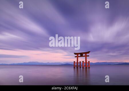 Long exposure shot of Shirahige shrine Torii gate at sunset at Lake Biwa, Shiga Prefecture, Japan Stock Photo