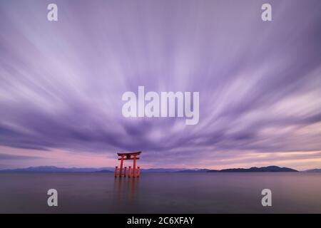 Long exposure shot of Shirahige shrine Torii gate at sunset at Lake Biwa, Shiga Prefecture, Japan Stock Photo