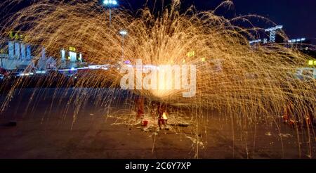 Artists perform molten iron splash near Qinggang highway interchange in Changchun city, northeast China's Jilin province, 7 June 2020. Stock Photo