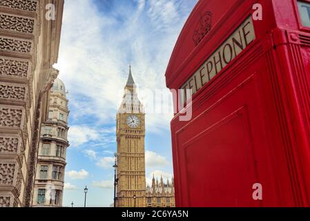 London - Big Ben tower and a red phone booth Stock Photo