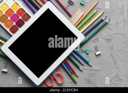 School supplies center composition on grey .concrete background Stock Photo