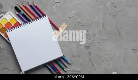 School supplies center composition on grey .concrete background Stock Photo