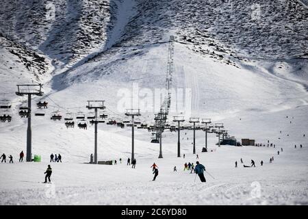 Tourists and sportsmen explore the pistes of Chunkurchak Ski Base in the Chuy Oblast of Kyrgyzstan near Bishkek. Stock Photo