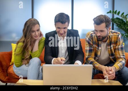 Young couple consulting with an agent while buying an apartment Stock Photo