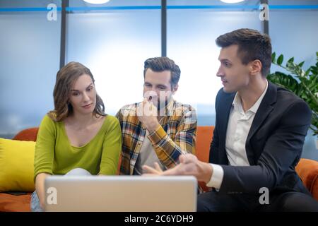 Sales agent showing a project to his clients Stock Photo
