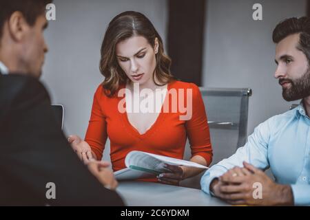 Man and woman reading legal papers at lawyers office Stock Photo