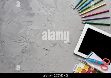 School supplies center composition on grey .concrete background Stock Photo