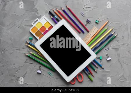 School supplies center composition on grey .concrete background Stock Photo