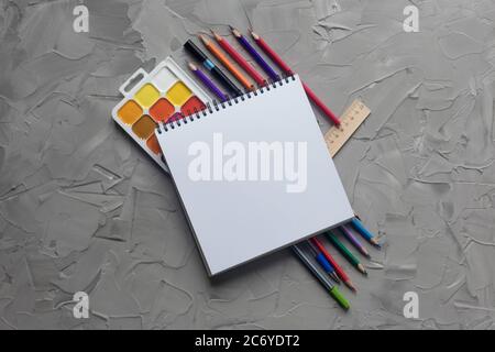 School supplies center composition on grey .concrete background Stock Photo