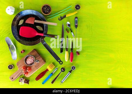 Kitchen utensils on a wooden background. Various kitchen utensils on wooden table. Chef tools. Home cooking. Stock Photo