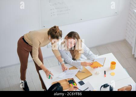 Business co-working of female, women. Beautiful modern ladies sitting in office and discussing new business ideas, share experience Stock Photo