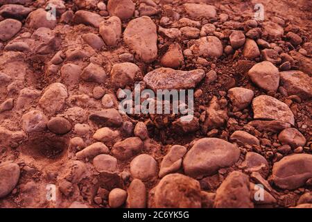 Stones background in sunset light. Orange brown color, texture. Stock Photo