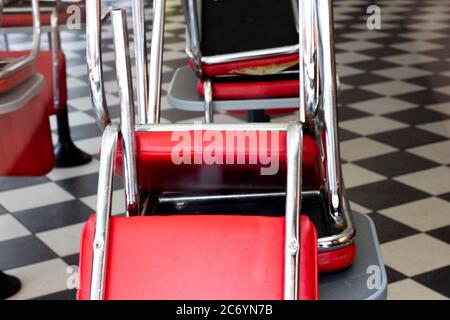 Restaurant with chairs stacked on tables closed for the retail sector lockdown due to the Coronavirus COVID 19 pandemic Stock Photo