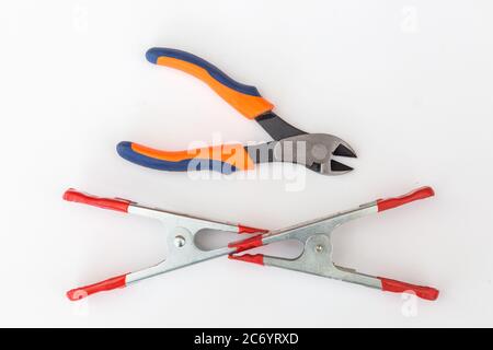 Side cutters and two A-clamps on white background. Stock Photo