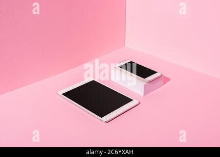 modern gadgets with blank screens on pink background Stock Photo
