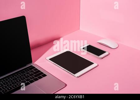 modern gadgets with blank screens on pink background Stock Photo