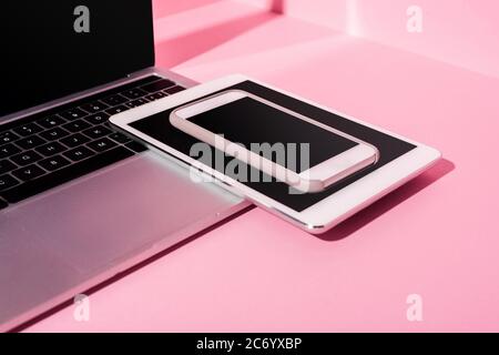 modern gadgets with blank screens on pink background Stock Photo