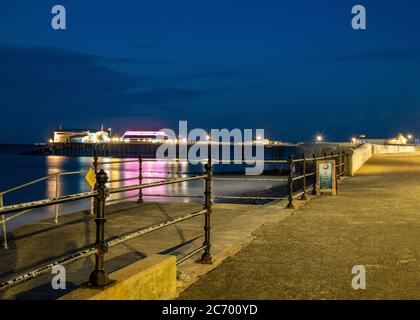 Cromer pier lit up at night in summer Stock Photo
