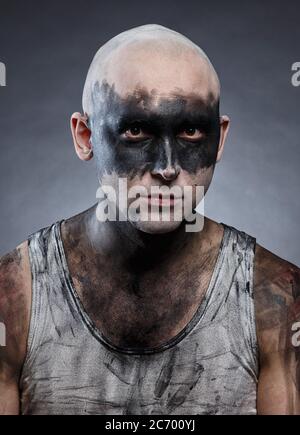 Portrait of young bald man with dirty make-up effect Stock Photo