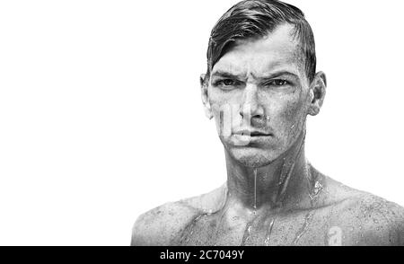Dramatic portrait of a male swimmer after workout on a white background. Wet hair. Water droplets. Young, handsome, strong guy Stock Photo