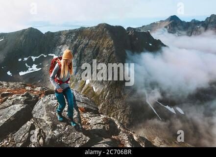 Hiking adventures woman trail running in mountains with backpack solo travel outdoor summer vacation trip in Norway healthy lifestyle concept Stock Photo