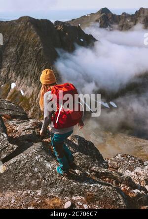 Hiking expedition woman backpacking in mountains alone travel adventure healthy lifestyle summer activity vacations outdoor extreme hobby trip in Norw Stock Photo