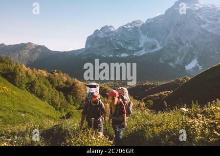 Couple family hiking with baby travel summer vacation man and woman outdoor healthy lifestyle adventure trip in mountains Stock Photo