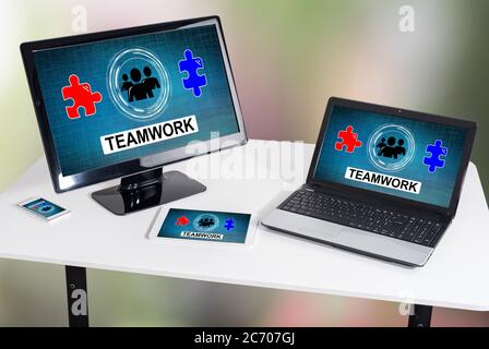 Teamwork concept shown on different information technology devices Stock Photo