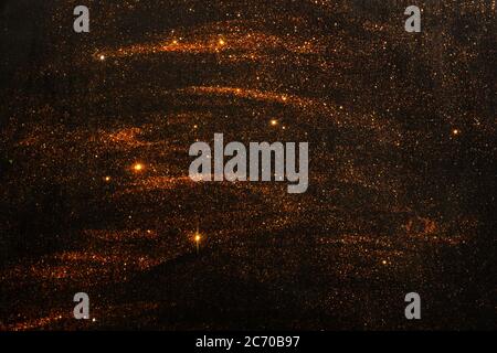 Abstract dark background with brilliant sequins as stars. A festive concept. Stock Photo