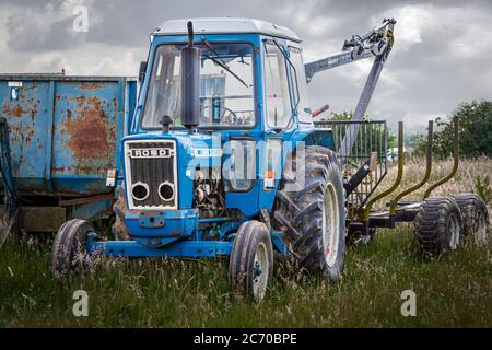 Ford 6600 tractor utility model with Riko trailer and crane Stock Photo